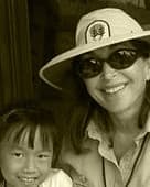 A Forest Ambassador in a ranger hat with a young visitor