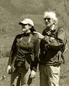 Two hikers in front of a snowy peak
