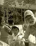 A volunteer showing children a nature display