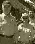 Three volunteers in uniform with trail tools
